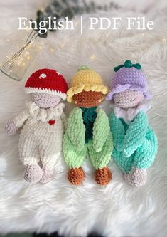 three crocheted stuffed animals sitting next to each other on top of a white blanket