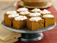 several pieces of cake on a plate with white frosting and napkins next to it