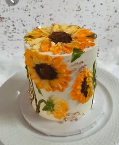 a white cake with yellow sunflowers on it