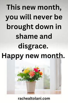 a vase filled with flowers sitting on top of a table next to a sign that says, this new month, you will never be brought down in shame and disgnce