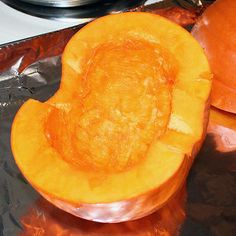 the inside of a pumpkin is cut open and ready to be put in the oven