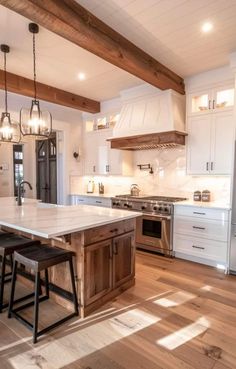 a large kitchen with an island and two stools