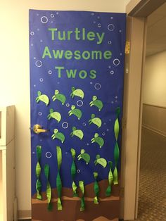 a door decorated with paper cutouts that says, turtley awesome two's