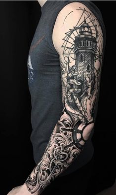 a man's arm with tattoos on it and an image of a lighthouse in the background