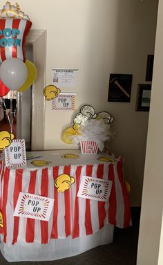 a table topped with popcorn bags and balloons