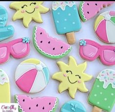 decorated cookies are arranged in the shape of sun, watermelon and umbrellas