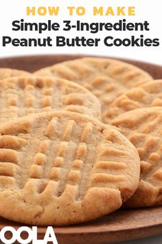 three peanut butter cookies sitting on top of a wooden plate