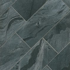 a close up view of a black slate tile flooring pattern that looks like it has been cut in half