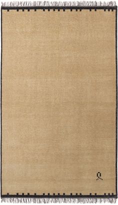 a beige rug with black trim and fringes