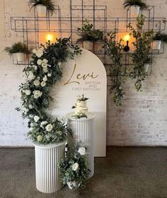 two white vases sitting next to each other near a sign that says leii first birthday