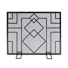 an iron fireplace screen with geometric designs on the top and bottom, shown in black