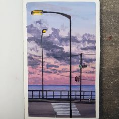 a painting of a street light next to the ocean