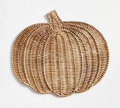 a woven pumpkin shaped basket on a white background