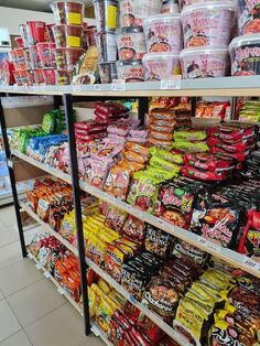 a store filled with lots of different types of food and snacks on shelves next to each other