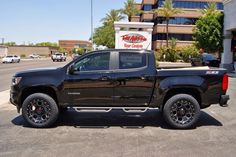 a black truck parked in front of a building