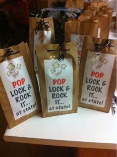 some bags that are on top of a table with the words pop, look and rock written on them