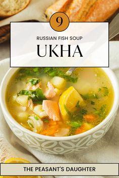 the russian fish soup is served in a bowl with bread and lemons on the side