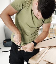 a man is working on some wood