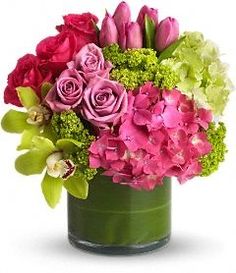 a vase filled with pink and green flowers