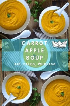 four bowls of carrot apple soup on a wooden table