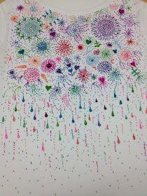 a white shirt with colorful fireworks on it