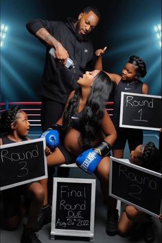 a man standing next to two women in front of chalkboards with writing on them