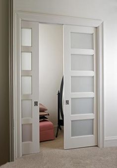 an open white door with glass panels on it