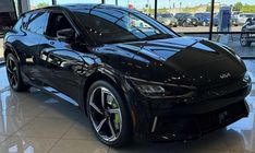 a black sports car parked in a showroom