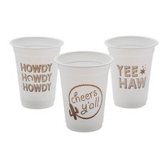 three white cups with brown lettering on them