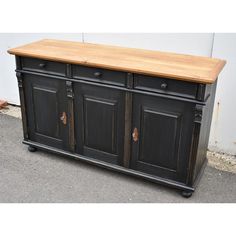 an old black buffet with wood top