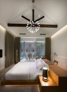 a large bed sitting under a wooden ceiling