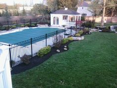 an above ground swimming pool surrounded by landscaping