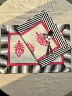 two placemats and a fork on a table