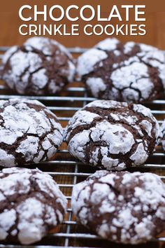 chocolate crinkle cookies cooling on a rack with powdered sugar in the middle