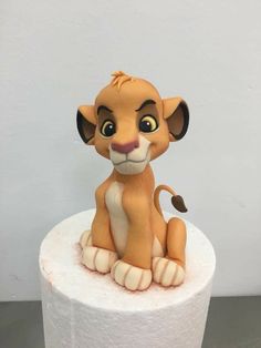 a lion figurine sitting on top of a toilet paper roll