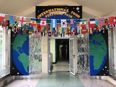 the entrance to an international school with flags hanging from it's walls and doors