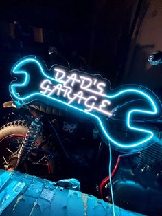 a neon sign that says dats garage on a motorcycle