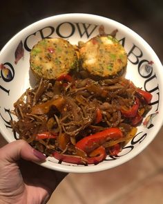 a person holding a plate with some food on it