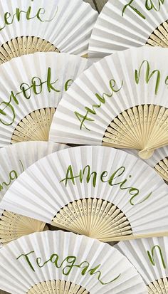 several white fans with green writing on them