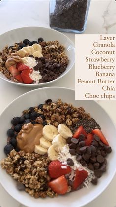 two white bowls filled with granola, strawberries, blueberry, banana and peanut butter