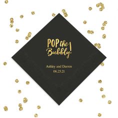 a black and gold wedding napkin with the words just married printed on it, surrounded by confetti