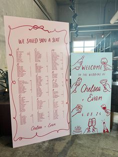 two wedding seating signs with red writing on them