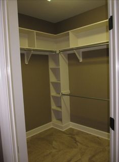 an empty walk - in closet with shelves and shelving