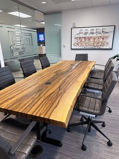 an empty conference room with chairs and a large wooden table