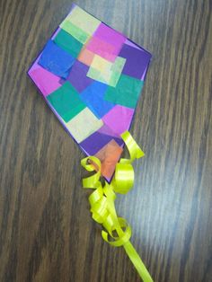 a piece of paper that has been made to look like a kite on a table