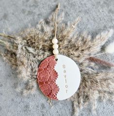 an ornament with the word say joy hanging from it's side on a feather