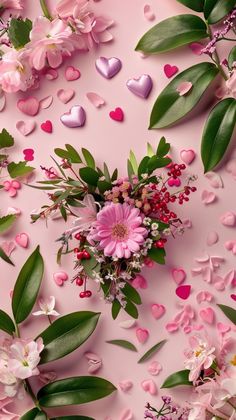 pink flowers and hearts on a pink background with greenery, leaves and confetti