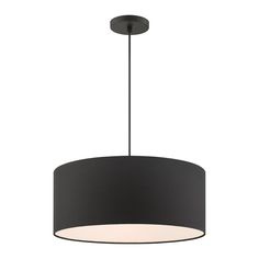 a black drum light hanging from the ceiling