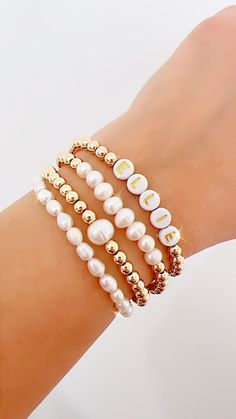 14k gold filled personalized bracelet, pearl bracelet, name word bracelet, birthday gift, bridesmaid, wedding, pearl stacking collection ❣️Beautiful and elegant beaded bracelet, made with 5mm 14k gold filled beads, acrylic letters and natural freshwater pearls❣️ ❣️Listing includes One bracelet. You can choose one or more bracelets, or the entire stack ( SUPER DEAL ❣️)  ❣️CREATE YOUR OWN STACK ❣️ These make fun, personalized gifts for moms, bachelorette parties, bridal showers, kids, flower girls, best friends...etc! Try personalizing with names, kids names, special words, phrases or affirmations, too  They are a stylish addition to any outfit, perfect for mixing, matching and stacking. The jewelry cord is elastic and will stretch slightly with wear.  -  14k gold filled beads *long lasting Acrylic Letters, Word Bracelet, Ball Bracelet, Personalized Gifts For Mom, Wedding Jewelry Bracelets, Wedding Bracelet, Quality Jewelry, Bracelet Sizes, Gifts For Girls