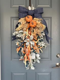 a blue door with a fall wreath hanging on it